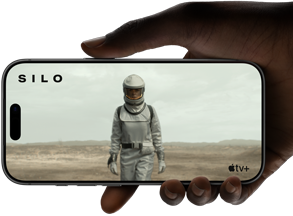 A hand holds an iPhone 17 Pro, Silver, horizontal, video playback on all-screen display demonstrating battery life